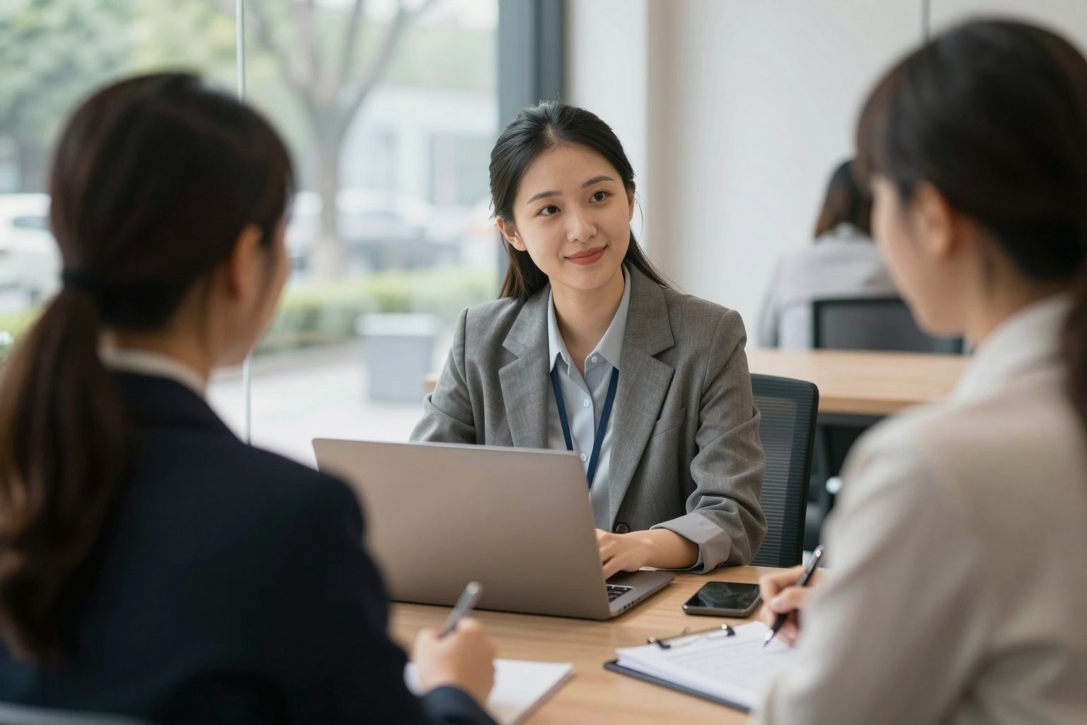 Colleagues meeting around a laptop in a bright office